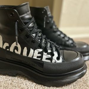 Black Alexander McQueen boots with white writing